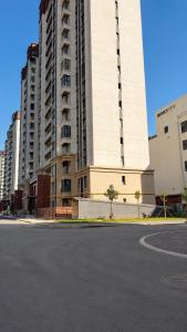 a large white building with tall buildings at High Town City in Lunacharskiy Bekati