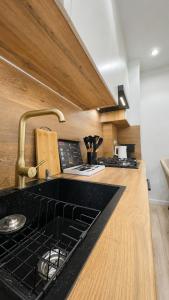 a kitchen with a black counter top and a sink at High Town City in Lunacharskiy Bekati