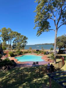 a swimming pool with a view of the water at The Gums Anchorage in Bellara