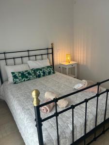 a bedroom with a bed with a black metal frame at Anna Coast Apartment in Agia Anna