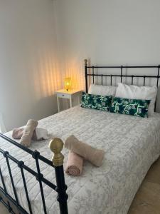 a bedroom with a bed with white sheets and pillows at Anna Coast Apartment in Agia Anna