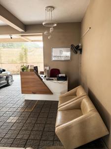 a office with a couch and a desk and a car at Dreams Arcade in Nedumbassery