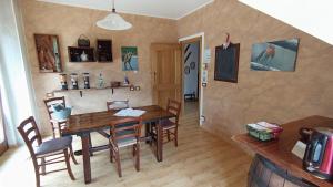 a dining room with a wooden table and chairs at LA ROCCA BIANCA in Demonte