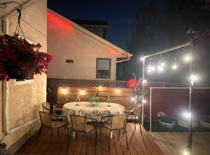 a table and chairs on a deck with lights at Brother Li Homestay in Calgary
