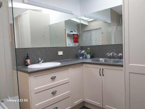 a bathroom with a sink and a mirror at Alba the Scots Cottage walk every where in Maleny +54 photos