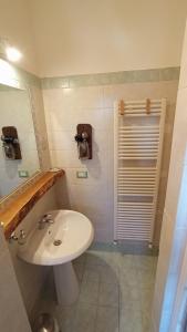 a bathroom with a white sink and a mirror at LA ROCCA BIANCA in Demonte +26 photos