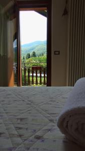 a bedroom with a bed and a window with a view at LA ROCCA BIANCA in Demonte