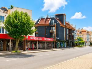 a street with shops on the side of a road at AM Sea Studios in Ravda +3 photos