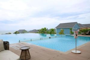 a swimming pool at a resort with a no swimming sign at Novaworld Phan Thiết - Alala Stay in Bình Sum