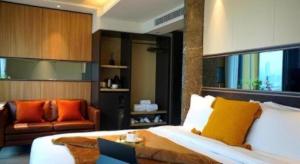 a bedroom with a bed and a couch and a chair at Ehotel in Hong Kong +65 photos