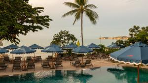a resort with a pool and chairs and umbrellas at SAii Koh Samui Villas - Adult only 12 plus in Choeng Mon Beach