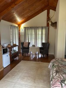 a living room with a table and chairs at Coppabella Cottage in Jingellic +17 photos