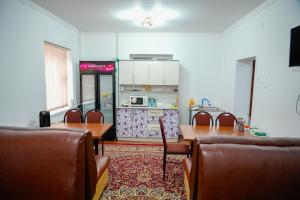 a room with a kitchen with a table and chairs at Meyman House in Karakol