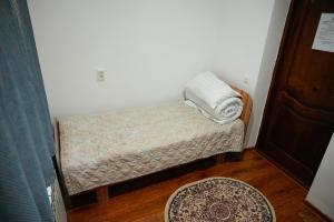 a small room with a bench with a pillow on it at Meyman House in Karakol