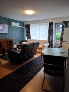 a living room with a couch and a table at Jyrängön Helmi in Heinola