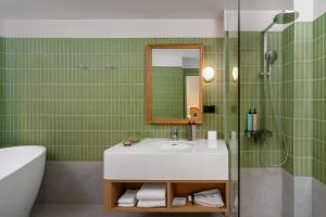 a bathroom with a sink and a mirror at Anantasila Beach Resort Hua Hin in Hua Hin