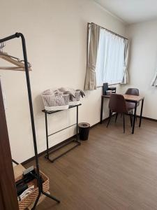 a room with a desk and a table and a window at Oyado SORARURI in Yakushima