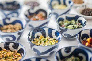 a group of blue and white bowls filled with food at ANA Crowne Plaza Matsuyama by IHG in Matsuyama