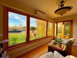 a living room with large windows and a couch and a table at H on the bund in Saskatoon +22 photos