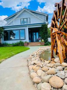 a house with a water feature in front of it at H on the bund in Saskatoon