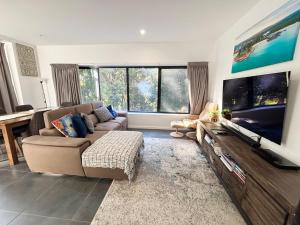 a living room with a large flat screen tv at Nineteen On Gregory G02 in South West Rocks
