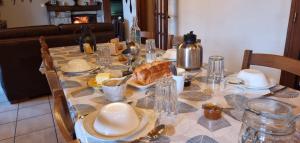 a table with a plate of food on it at Les Chambres du Saladou in Mont-Chanson +16 photos