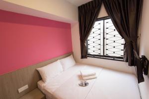 a small bedroom with a bed with a window at HomeStay 21 Hotel in Johor Bahru