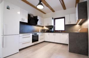 a large kitchen with white cabinets and a window at statek P22 in Semněvice