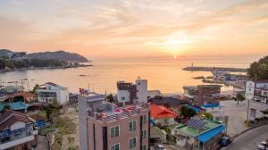 an aerial view of a city with the ocean at Samcheok Jisu Pension in Samcheok