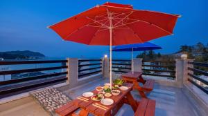 a table with plates of food and an umbrella at Samcheok Jisu Pension in Samcheok