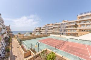 an apartment with a tennis court in front of a building at Beach Sunset - Apartment Ocean in Vila Nova de Gaia