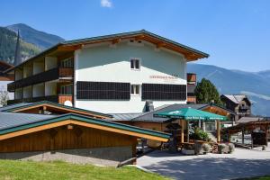 a hotel in the mountains with mountains in the background at Gästehaus Waltl in Krimml