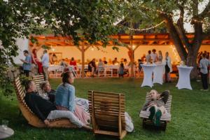 a group of people sitting on lawn chairs in the grass at statek P22 in Semněvice