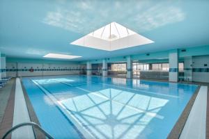 a large swimming pool with a skylight in a building at Beach Sunset - Apartment Ocean in Vila Nova de Gaia