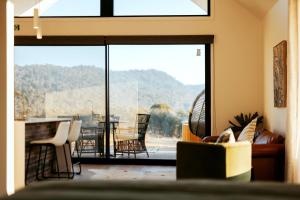 a living room with a view of a table and chairs at Glenbosch - Cottage One in Beechworth