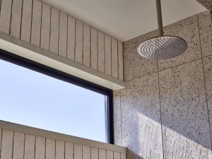 a shower with a glass door and a window at Glenbosch - Cottage One in Beechworth