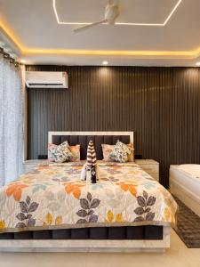 a bedroom with a bed with a stuffed animal on it at Elvora Stay's - Studio with Jacuzzi in Ghaziabad