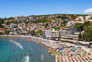 a beach with a bunch of people in the water at Apartments Lazo in Ulcinj +8 photos
