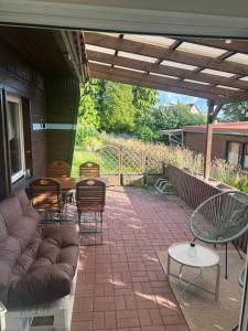 a patio with a couch and chairs and a table at Bungalow Friedrich in Thale