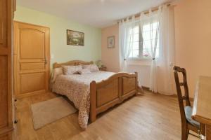 a bedroom with a bed and a window at Gîte du Pont d 'Amourette in Mayenne +8 photos