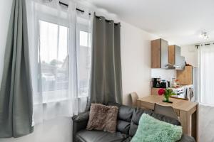 a living room with a couch and a window at Haus Seeluft - W1 in Butjadingen +10 photos