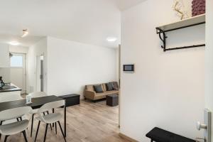 a dining room and living room with a table and chairs at Haus Seeluft - W3 in Butjadingen