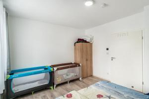 a bedroom with a bunk bed and a room with a bed at Haus Seeluft - W1 in Butjadingen