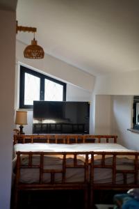 a room with two beds and a large window at Tenuta Bellassai in SantʼAlessio Siculo