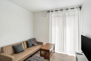 a living room with a couch and a table at Haus Seeluft - W3 in Butjadingen