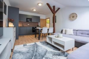a living room with a couch and a table at G&T Square Apartments in Liptovský Mikuláš