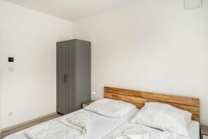 a bedroom with a bed with two pillows at Haus Seeluft - W3 in Butjadingen