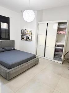 a bedroom with a bed and a closet at וילת צאלים in Yeroẖam +9 photos