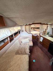 an interior view of a room with two beds in an rv at Sunset boat in Leucate-Plage