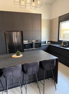 a kitchen with a large table with four chairs at וילת צאלים in Yeroẖam